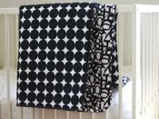 black dots and numbers beding by quilt baby